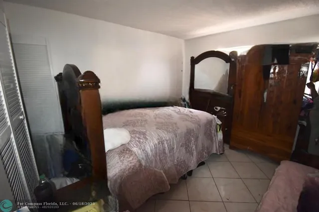 a bedroom with a bed and a mirror
