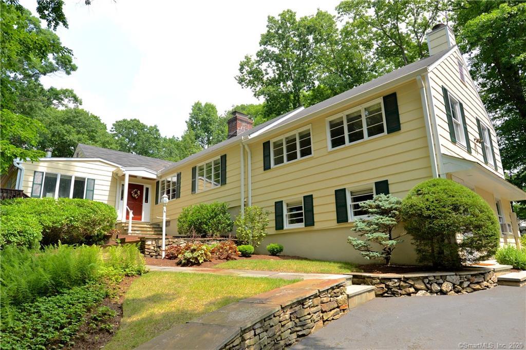 31 Powder Horn Hill Road Wilton, CT 06897 - Photo 1 of 16 a front view of a house with yard and green space