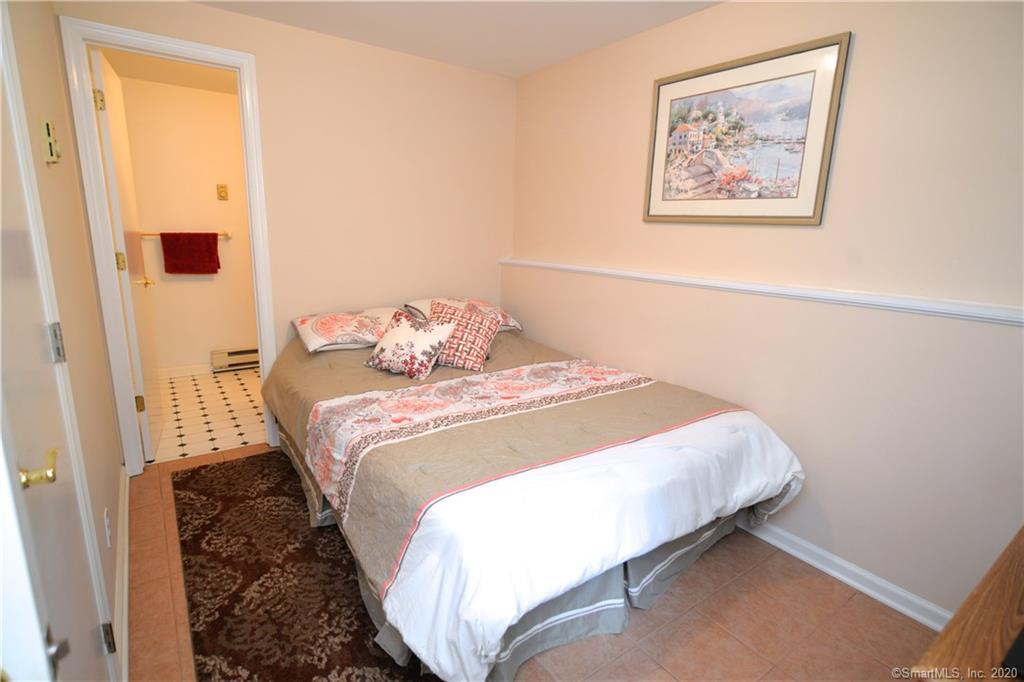 31 Powder Horn Hill Road Wilton, CT 06897 - Photo 10 of 16 a bedroom with a bed and a wall painting