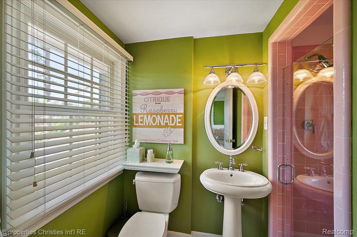 135 Clifton Road Bloomfield Hills, MI 48301 - Photo 47 of 77 Bathroom featuring a pedestal sink, oval vanity mirror, and a window with horizontal blinds