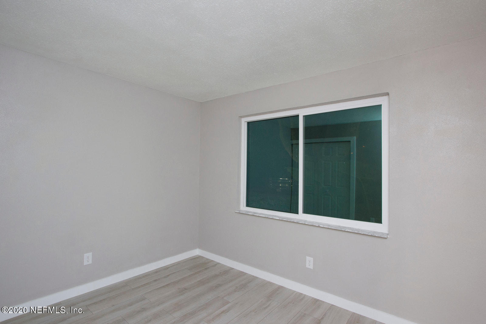 650 Pope Road, Unit 246 St. Augustine, FL 32080 - Photo 13 of 26 a view of an empty room with wooden floor and a window