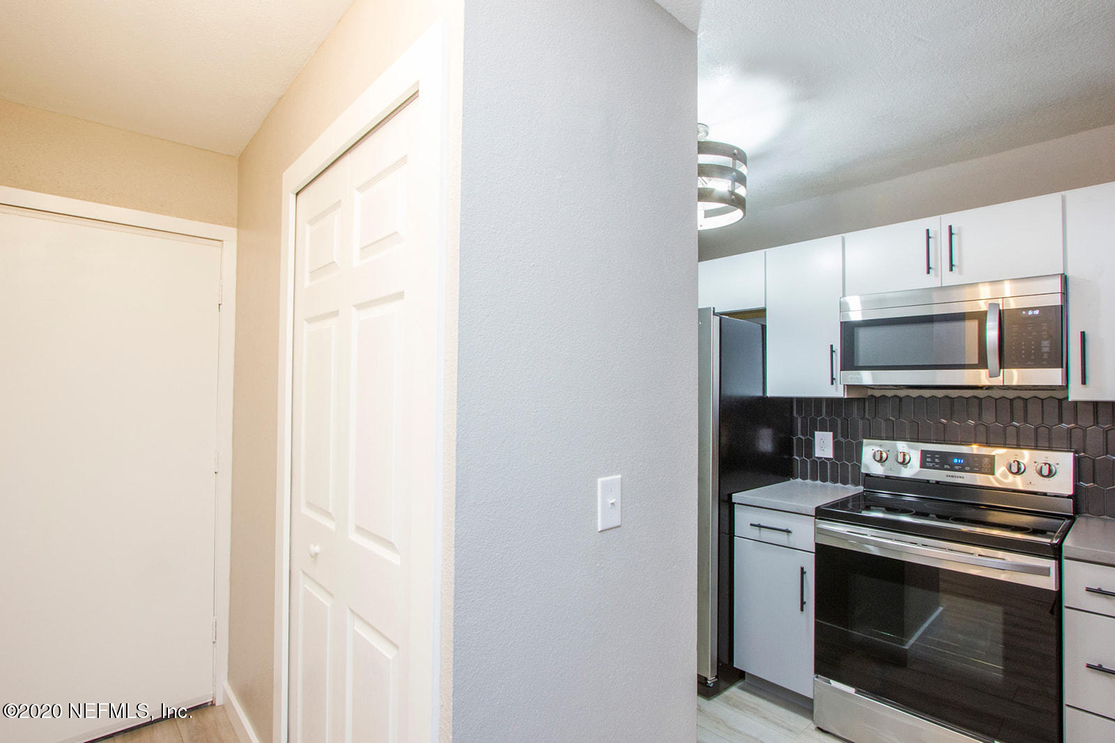 650 Pope Road, Unit 246 St. Augustine, FL 32080 - Photo 5 of 26 a kitchen with stainless steel appliances a stove a microwave and cabinets