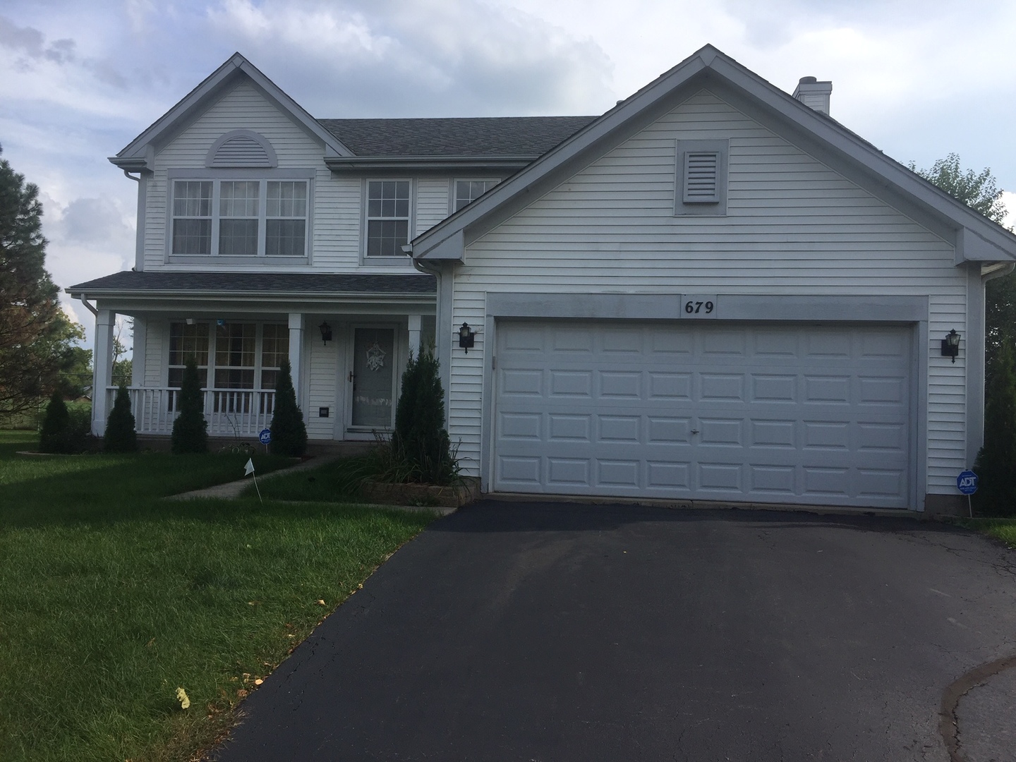 679 Maple Drive Streamwood, IL 60107 - Photo 1 of 1 a front view of a house with a garden and yard