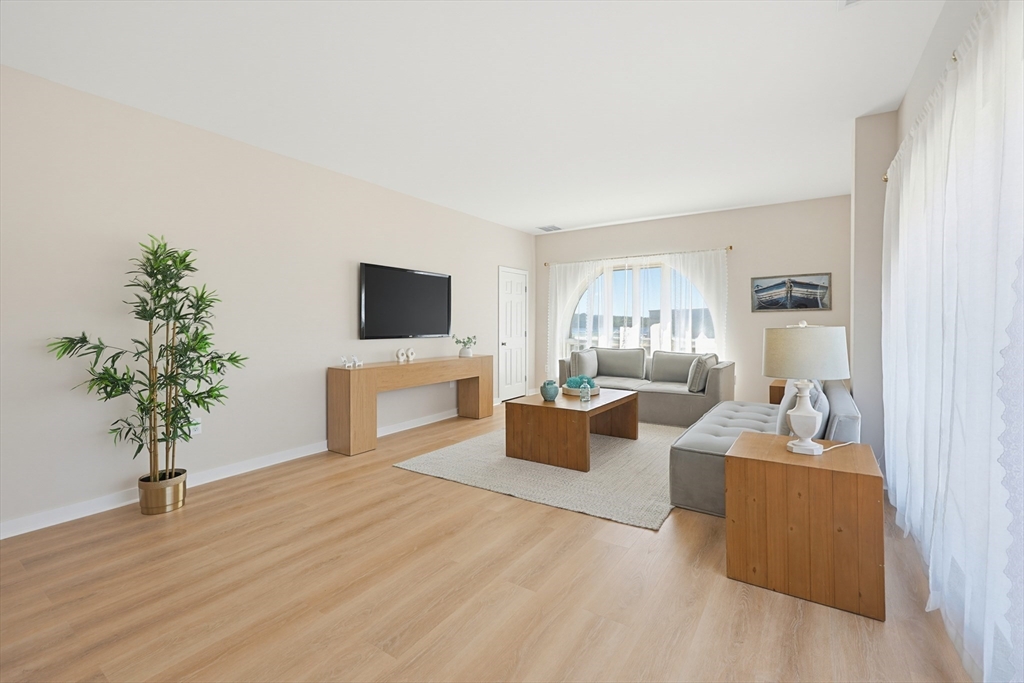 45 Main Street, Unit 35 Wareham, MA 02571 - Photo 11 of 34 a living room with furniture potted plant and a flat screen tv