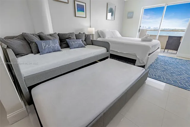 a living room with couches and large mirror on dresser