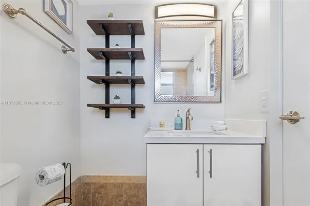 a bathroom with a sink a toilet and mirror
