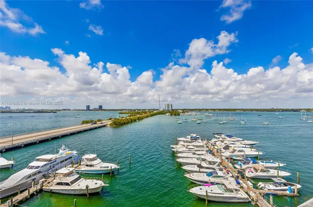 a view of a lake with lawn chairs