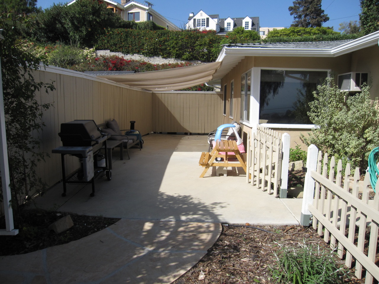 947 Cheltenham Road Santa Barbara, CA 93105 - Photo 22 of 35 a view of a patio with table and chairs potted plants