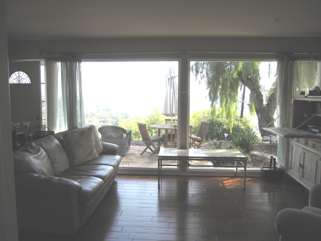 947 Cheltenham Road Santa Barbara, CA 93105 - Photo 24 of 35 a living room with furniture and floor to ceiling windows