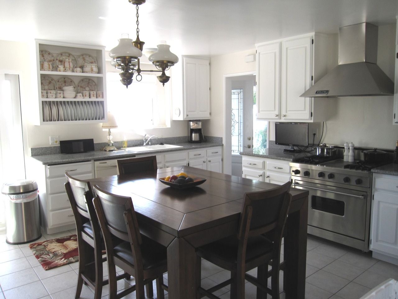 947 Cheltenham Road Santa Barbara, CA 93105 - Photo 9 of 35 a kitchen with a stove a sink a dining table and chairs