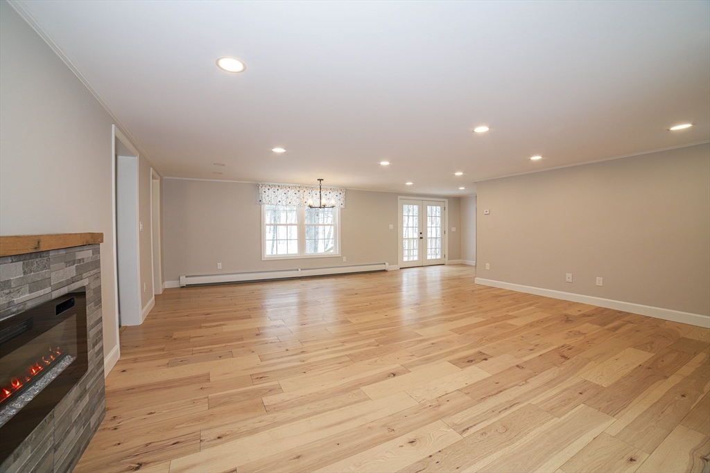3 Woods Road Westminster, MA 01473 - Photo 14 of 42 a view of empty room with wooden floor and fireplace