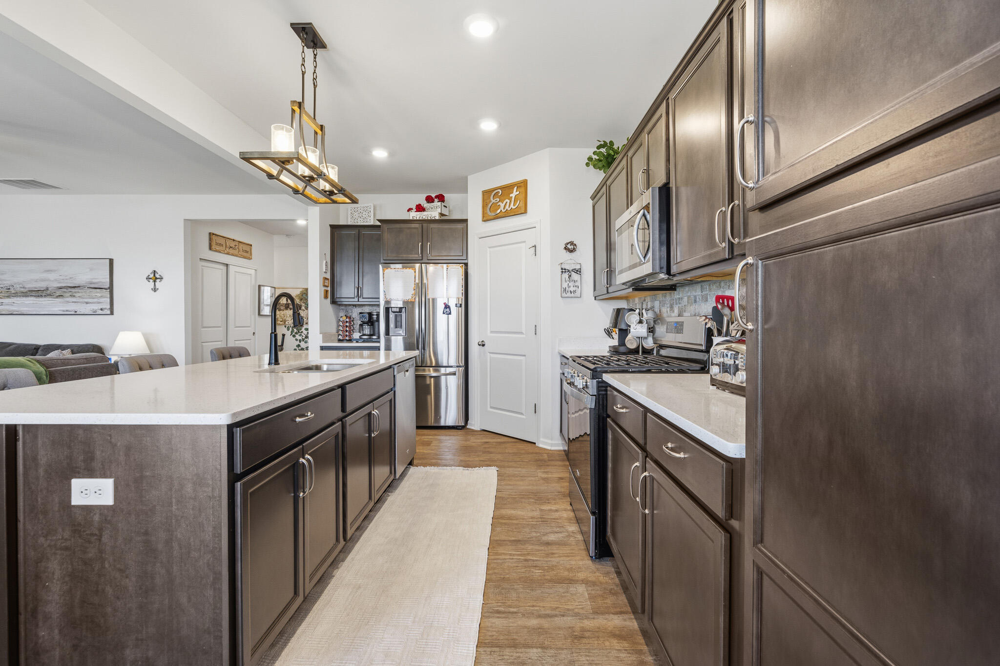7700 West 105th Avenue Crown Point, IN 46307 - Photo 11 of 39 a kitchen with stainless steel appliances granite countertop a sink a stove and a refrigerator