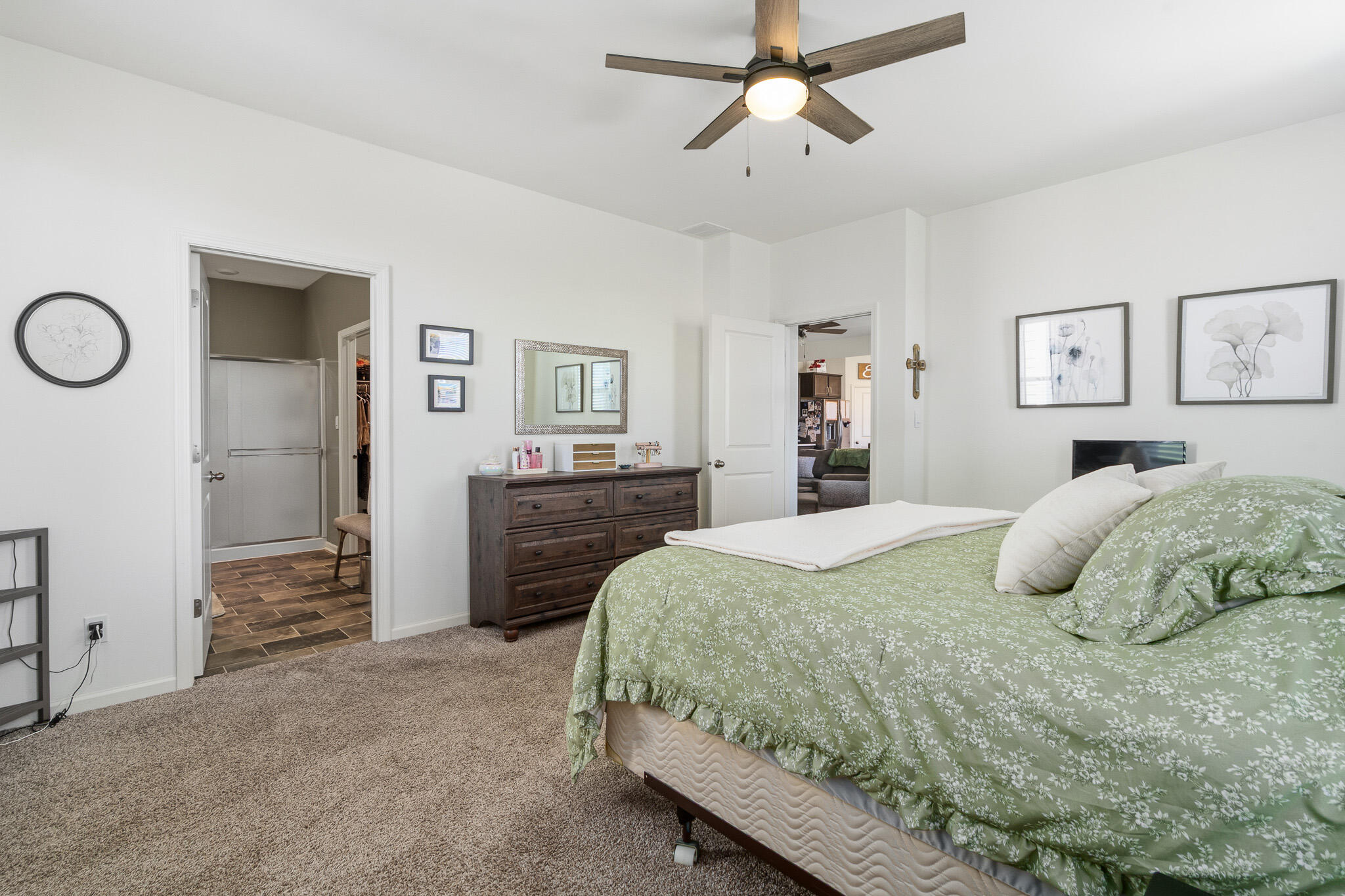 7700 West 105th Avenue Crown Point, IN 46307 - Photo 14 of 39 a bedroom with a large bed and a chandelier