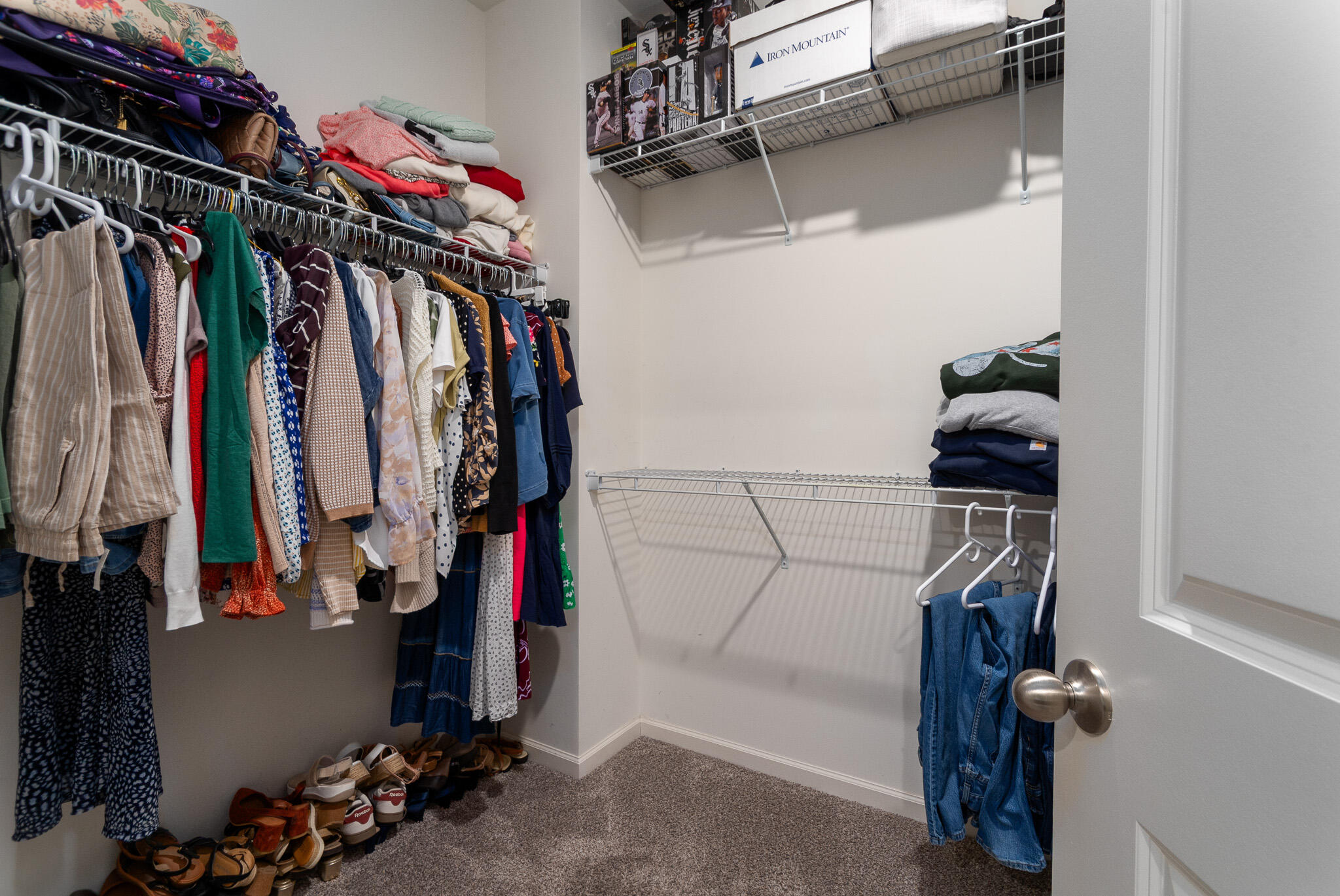 7700 West 105th Avenue Crown Point, IN 46307 - Photo 17 of 39 a view of walk in closet with clothes and shoes