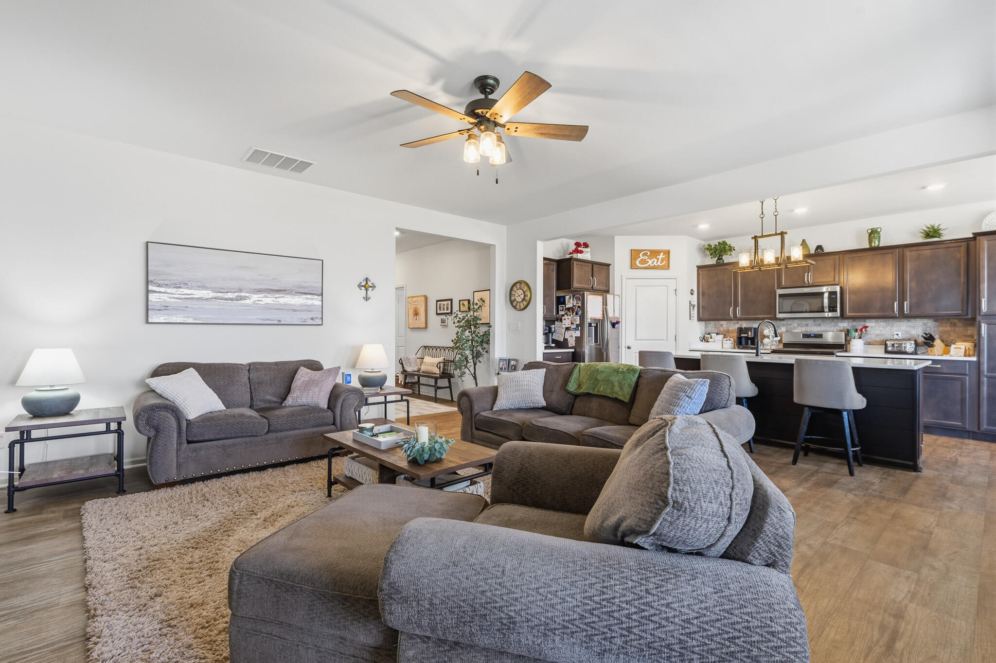 7700 West 105th Avenue Crown Point, IN 46307 - Photo 2 of 39 a living room with furniture kitchen view and a chandelier