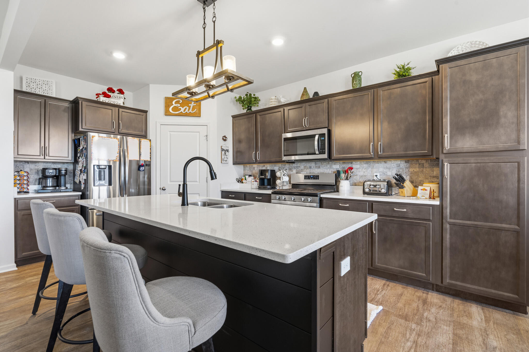 7700 West 105th Avenue Crown Point, IN 46307 - Photo 6 of 39 a kitchen with stainless steel appliances a sink stove and refrigerator