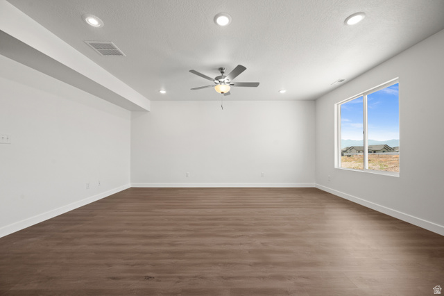 1554 Pheasant Road Eagle Mountain, UT 84005 - Photo 7 of 29 Spare room featuring dark wood-type flooring, a ceiling fan, and recessed lighting