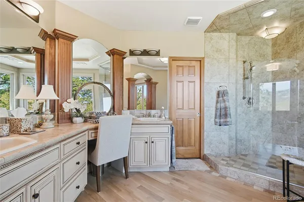 a spacious bathroom with a double vanity sink mirror and shower