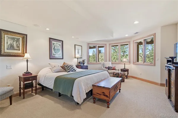 a spacious bedroom with a bed and a window