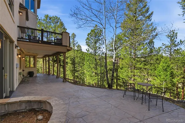 a view of a patio with table and chairs and potted plants