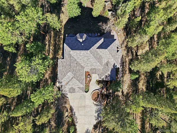 an aerial view of a house with a yard and garden