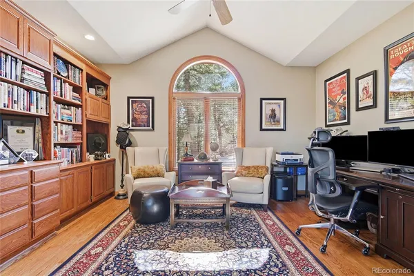 a living room with furniture a rug and a window