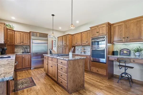 a kitchen with stainless steel appliances granite countertop a stove oven and a refrigerator