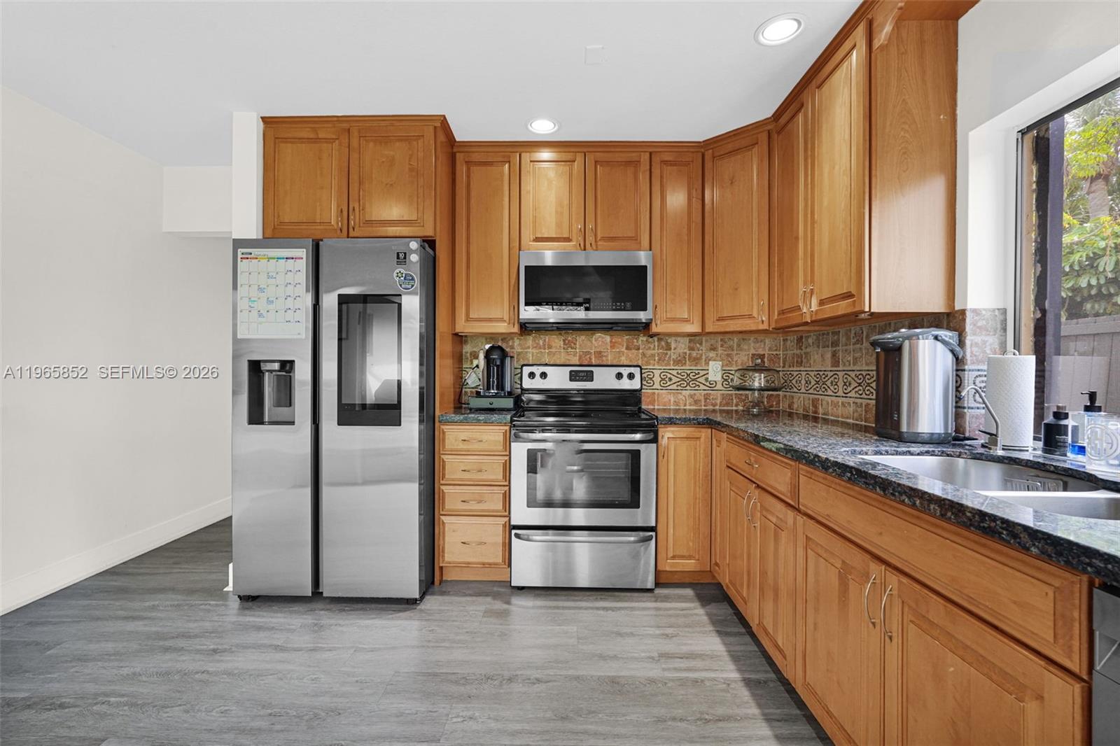 7635 Sierra Terrace West Boca Raton, FL 33433 - Photo 18 of 53 a kitchen with stainless steel appliances a refrigerator sink and microwave