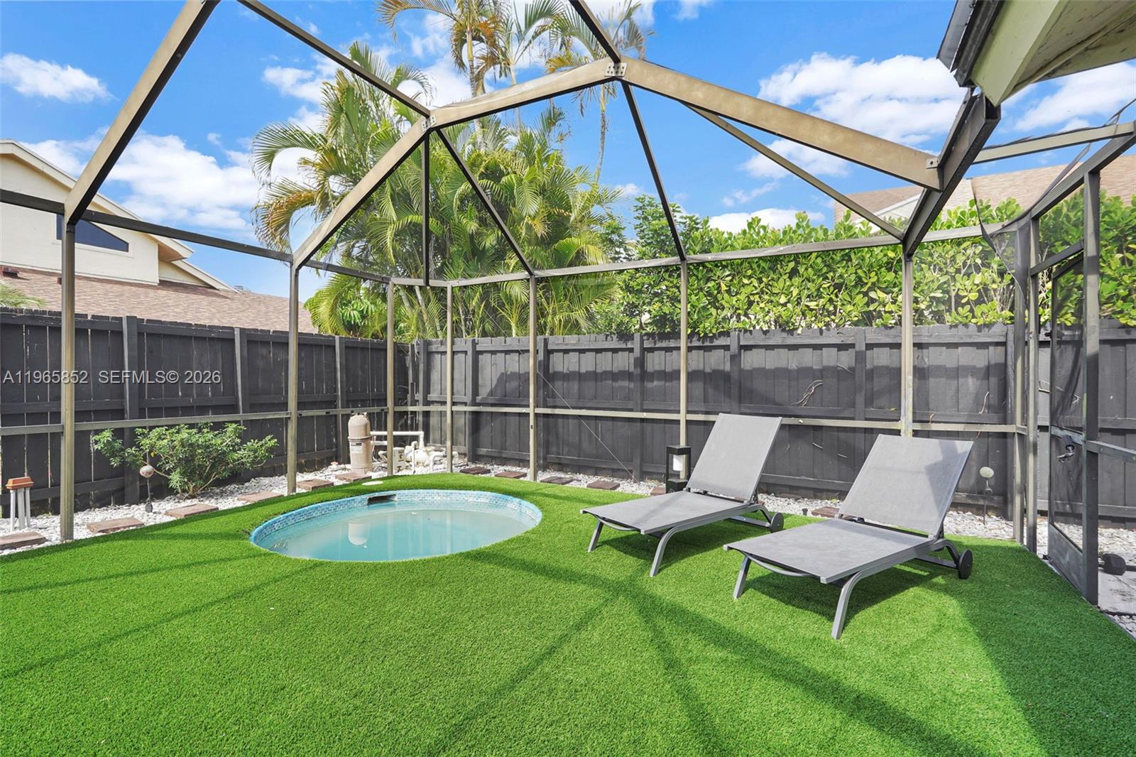 7635 Sierra Terrace West Boca Raton, FL 33433 - Photo 2 of 53 a view of a backyard with a table and chairs