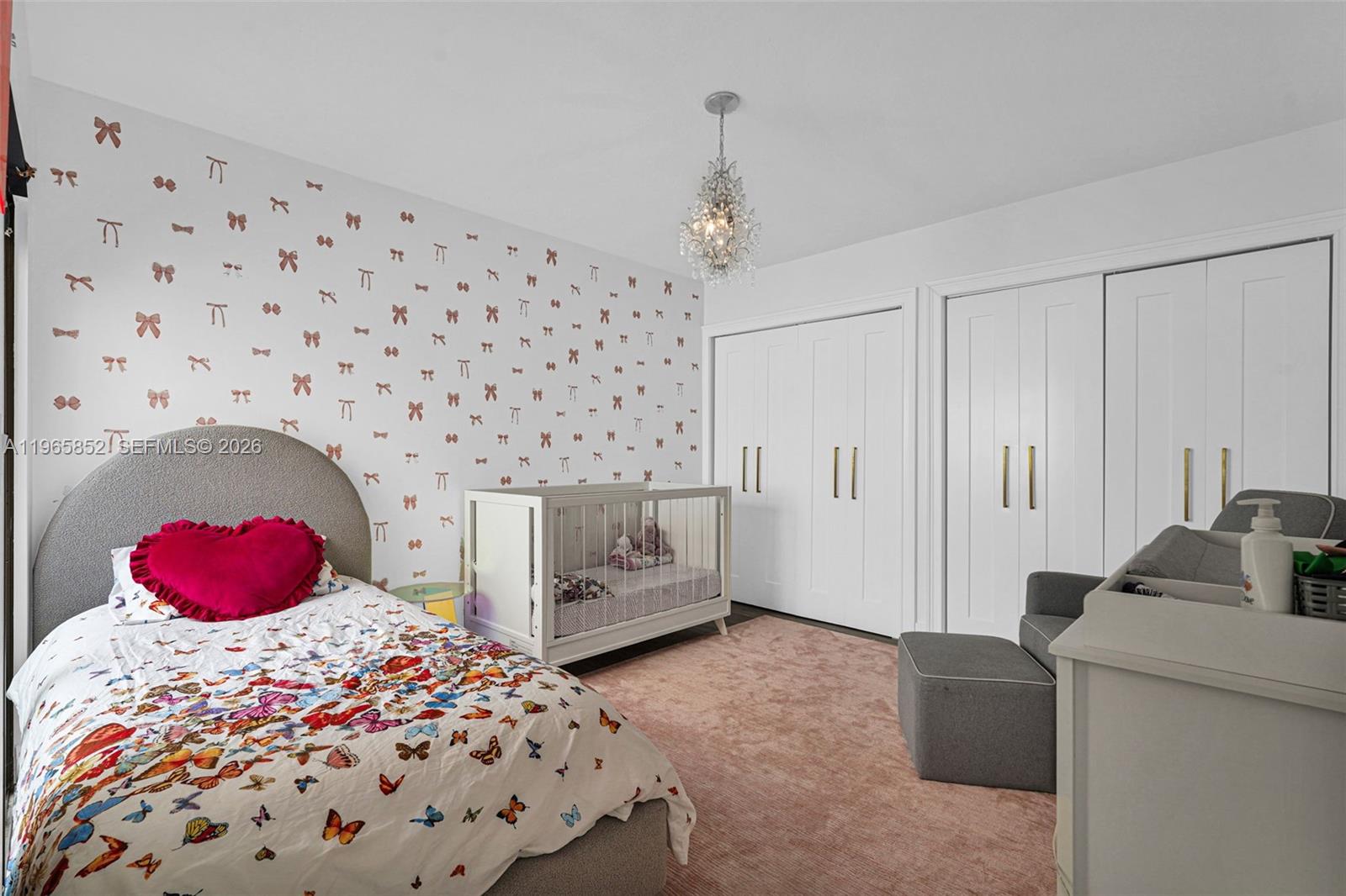 7635 Sierra Terrace West Boca Raton, FL 33433 - Photo 29 of 53 a bedroom with a bed and a chandelier