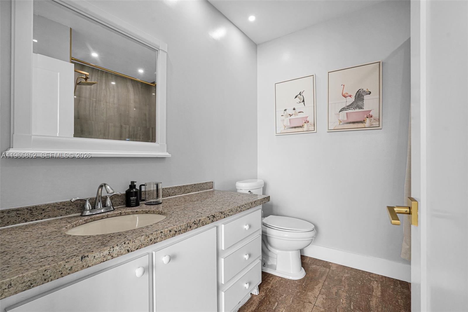7635 Sierra Terrace West Boca Raton, FL 33433 - Photo 37 of 53 a bathroom with a granite countertop sink mirror vanity and toilet