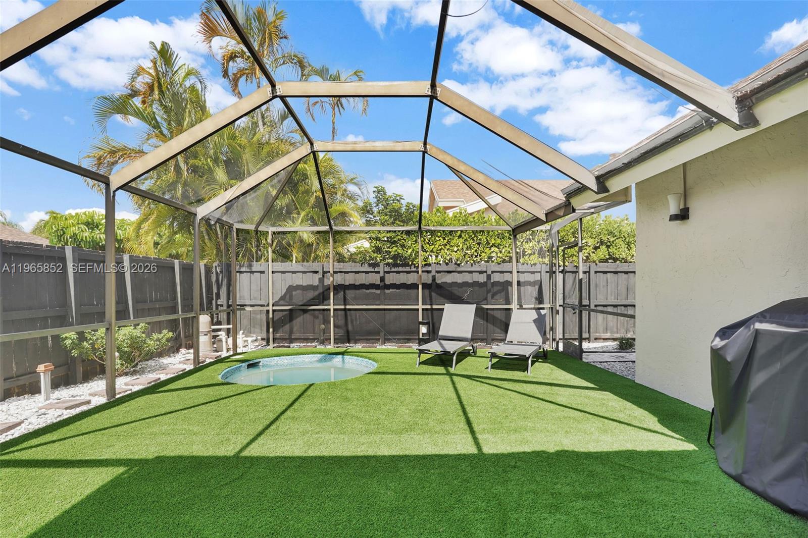 7635 Sierra Terrace West Boca Raton, FL 33433 - Photo 40 of 53 a view of a backyard with a small cabin and a chair