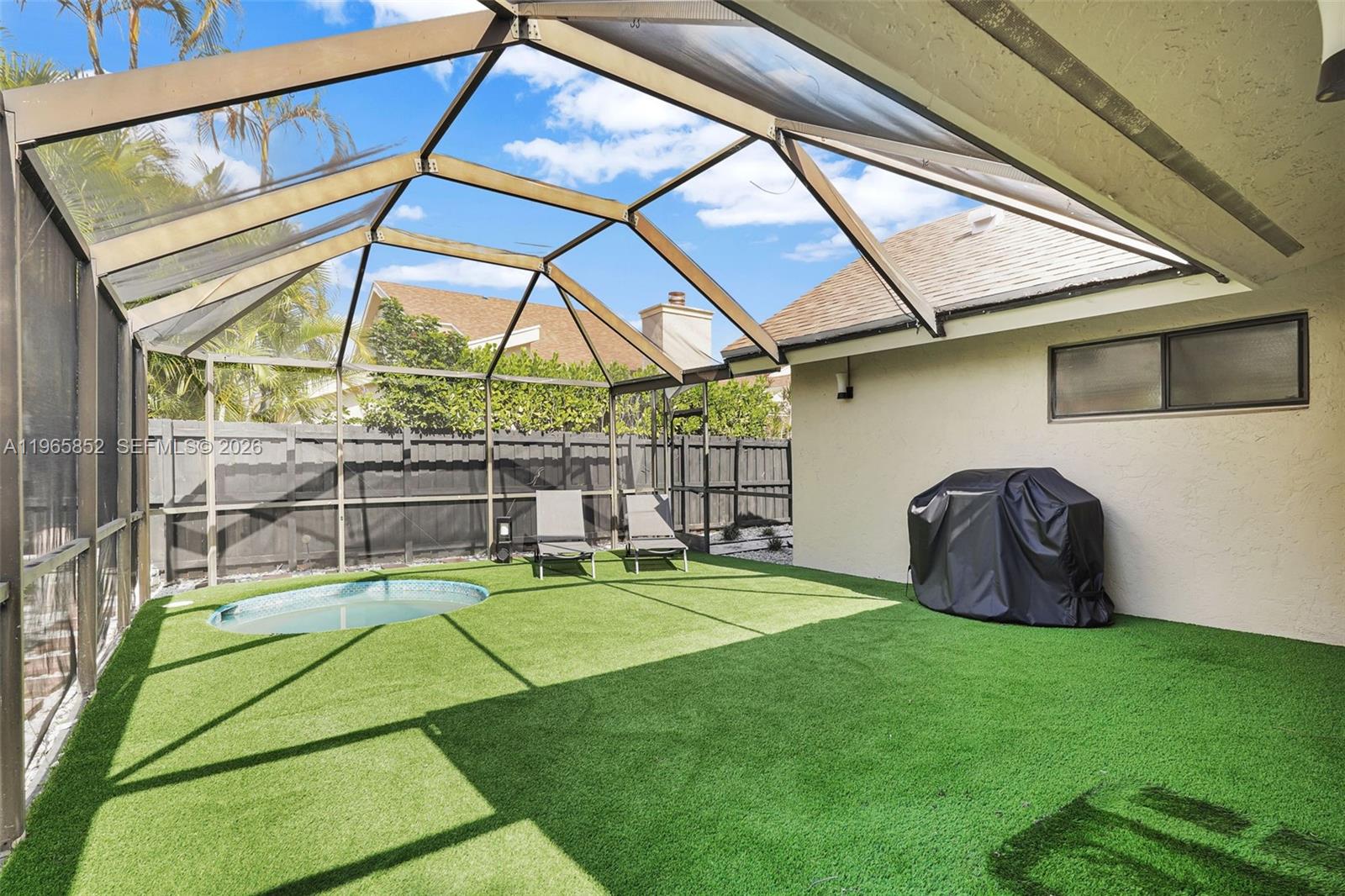 7635 Sierra Terrace West Boca Raton, FL 33433 - Photo 43 of 53 a backyard of a house with table and chairs
