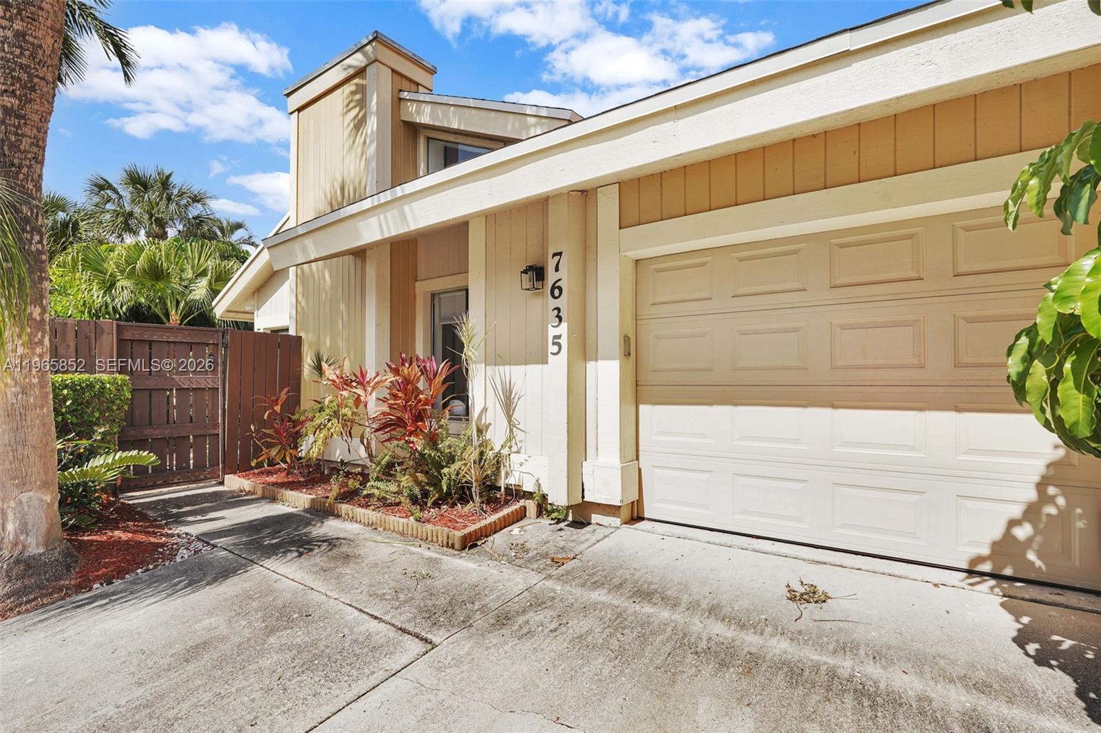 7635 Sierra Terrace West Boca Raton, FL 33433 - Photo 52 of 53 a front view of a house with a yard and potted plants