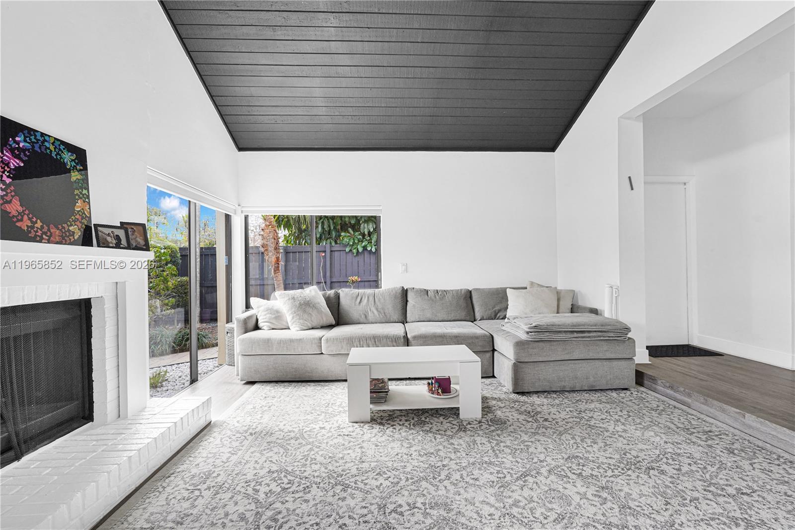 7635 Sierra Terrace West Boca Raton, FL 33433 - Photo 7 of 53 a living room with furniture a fireplace and a large window