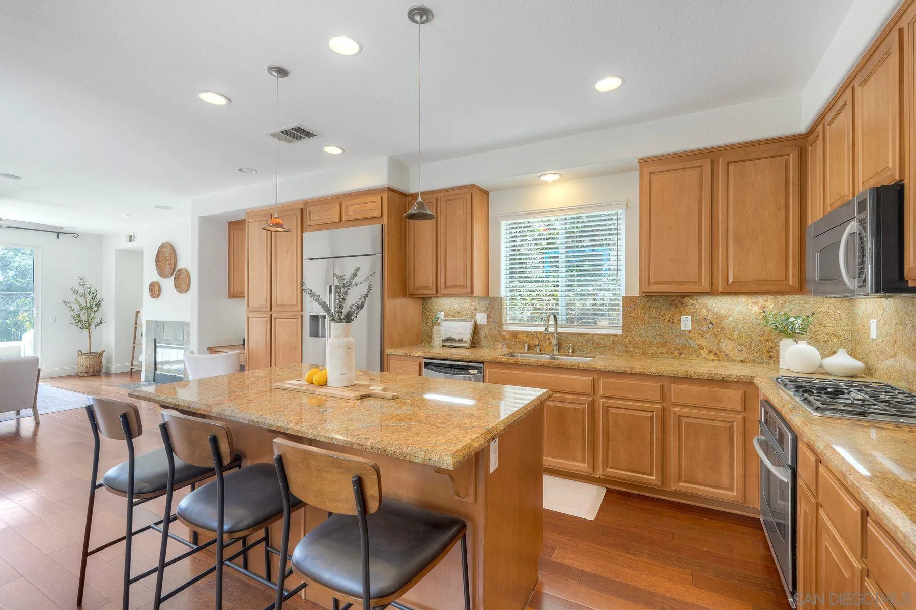 1614 Reflection Street San Marcos, CA 92078 - Photo 15 of 40 a kitchen with granite countertop a sink and counter space