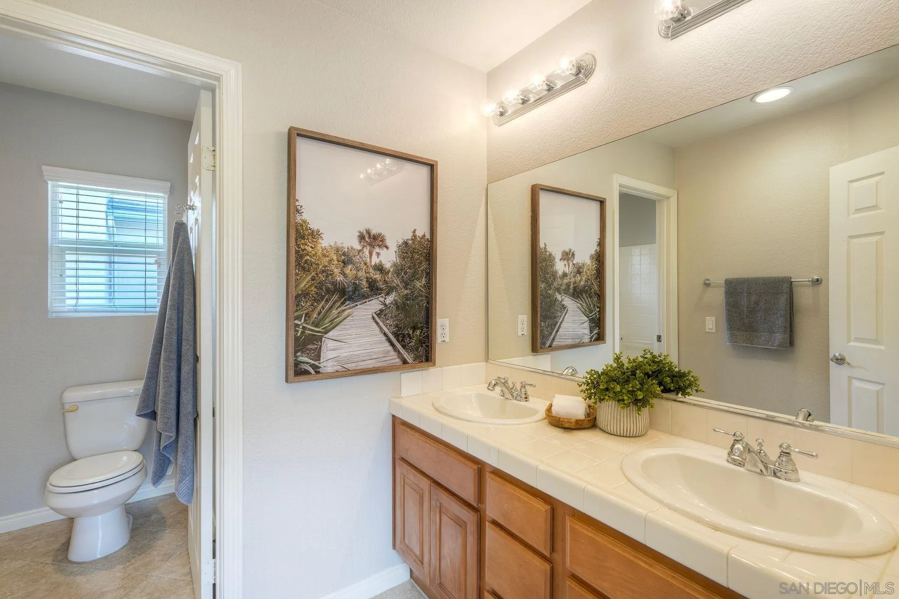 1614 Reflection Street San Marcos, CA 92078 - Photo 26 of 40 a bathroom with a granite countertop sink toilet and shower