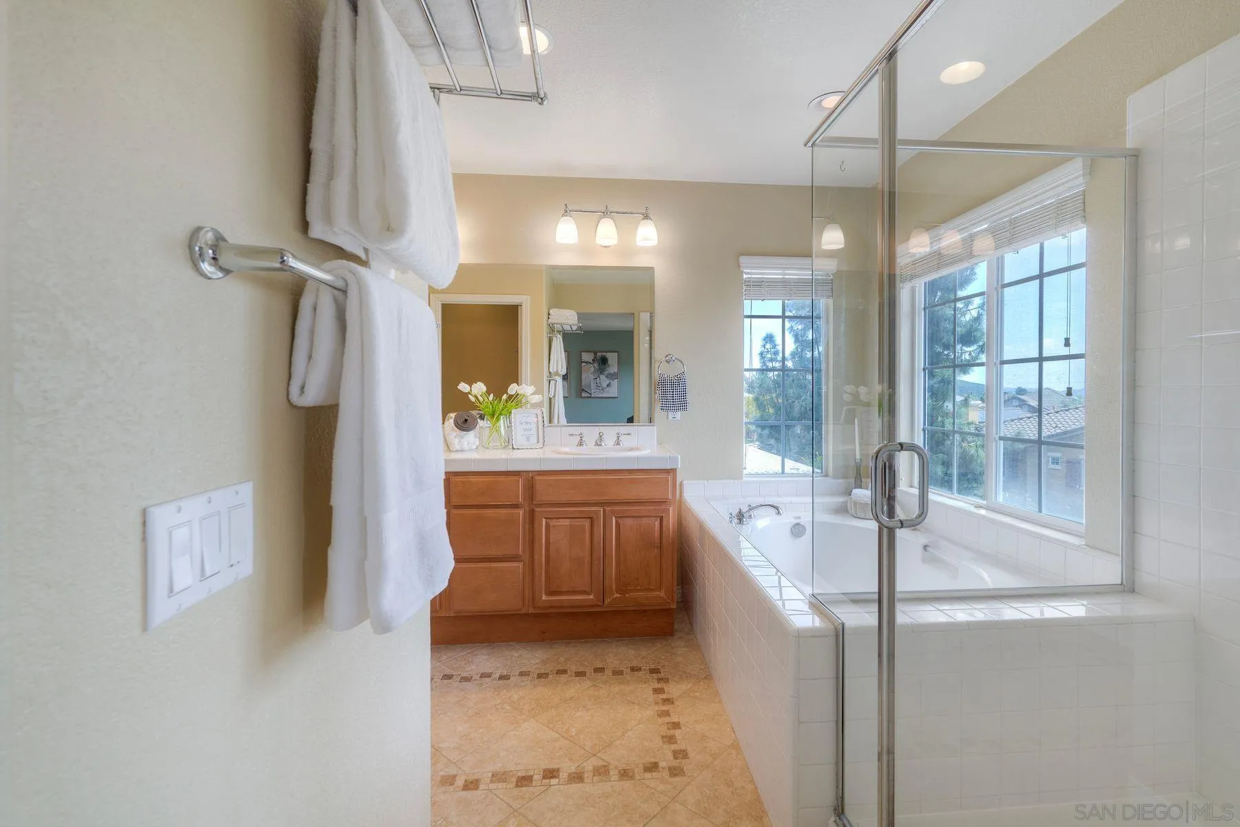 1614 Reflection Street San Marcos, CA 92078 - Photo 33 of 40 a bathroom with a tub sink shower and mirror
