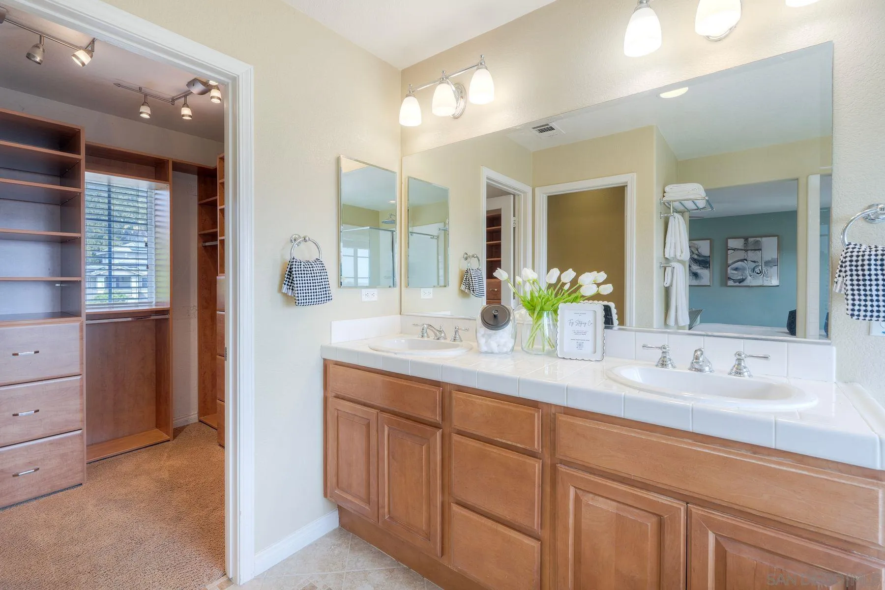 1614 Reflection Street San Marcos, CA 92078 - Photo 34 of 40 a bathroom with a double vanity sink and a mirror