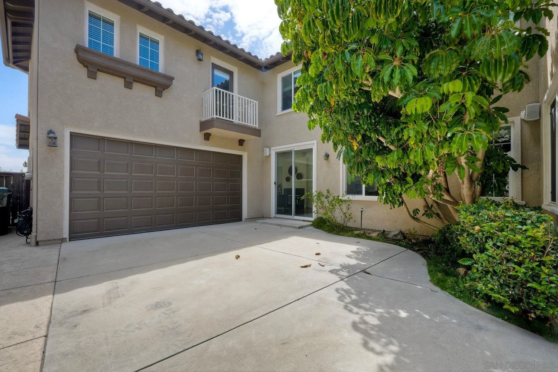1614 Reflection Street San Marcos, CA 92078 - Photo 4 of 40 a front view of a house with a yard and garage