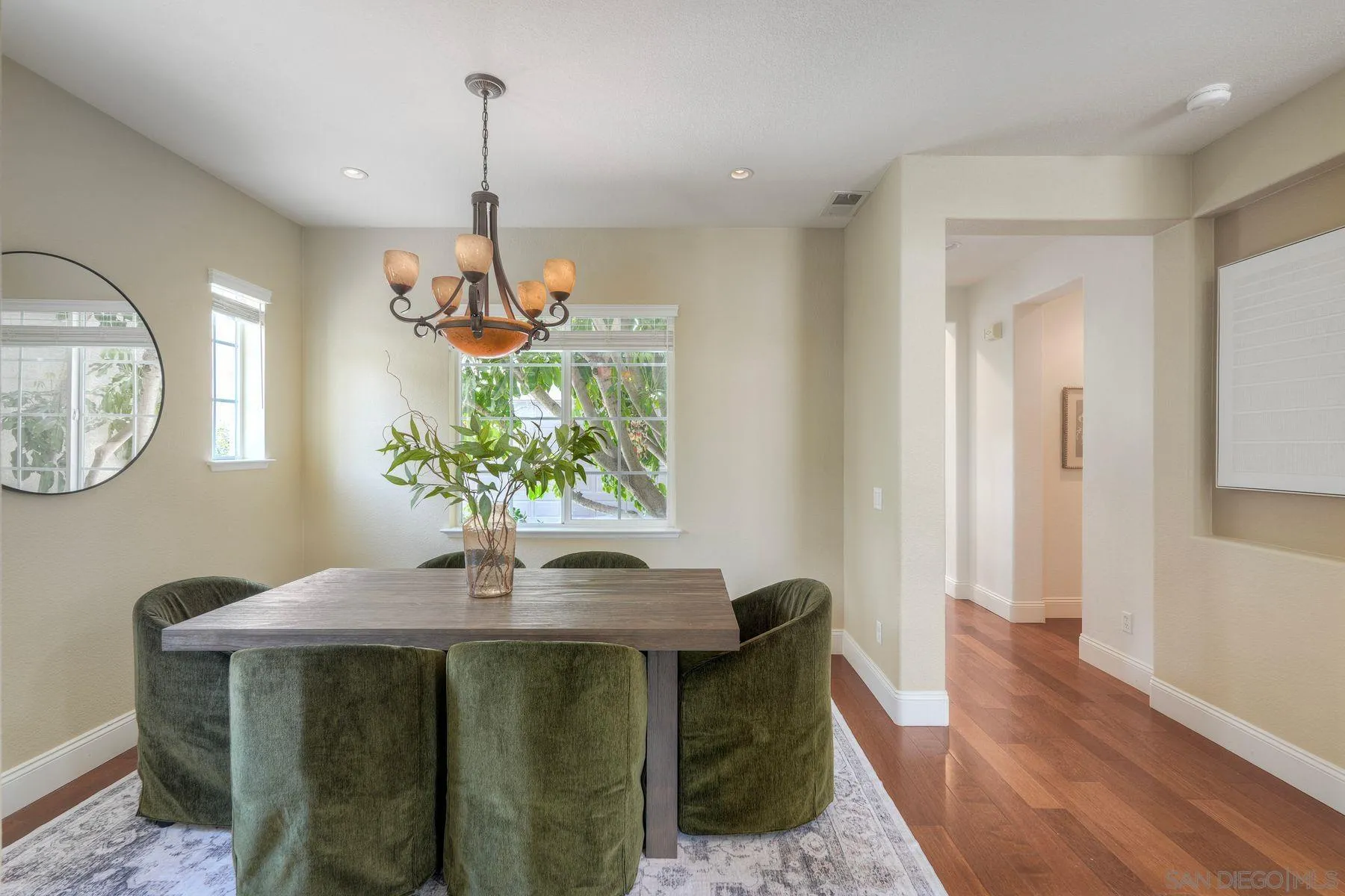 1614 Reflection Street San Marcos, CA 92078 - Photo 8 of 40 a dining room with chandelier and wooden floor