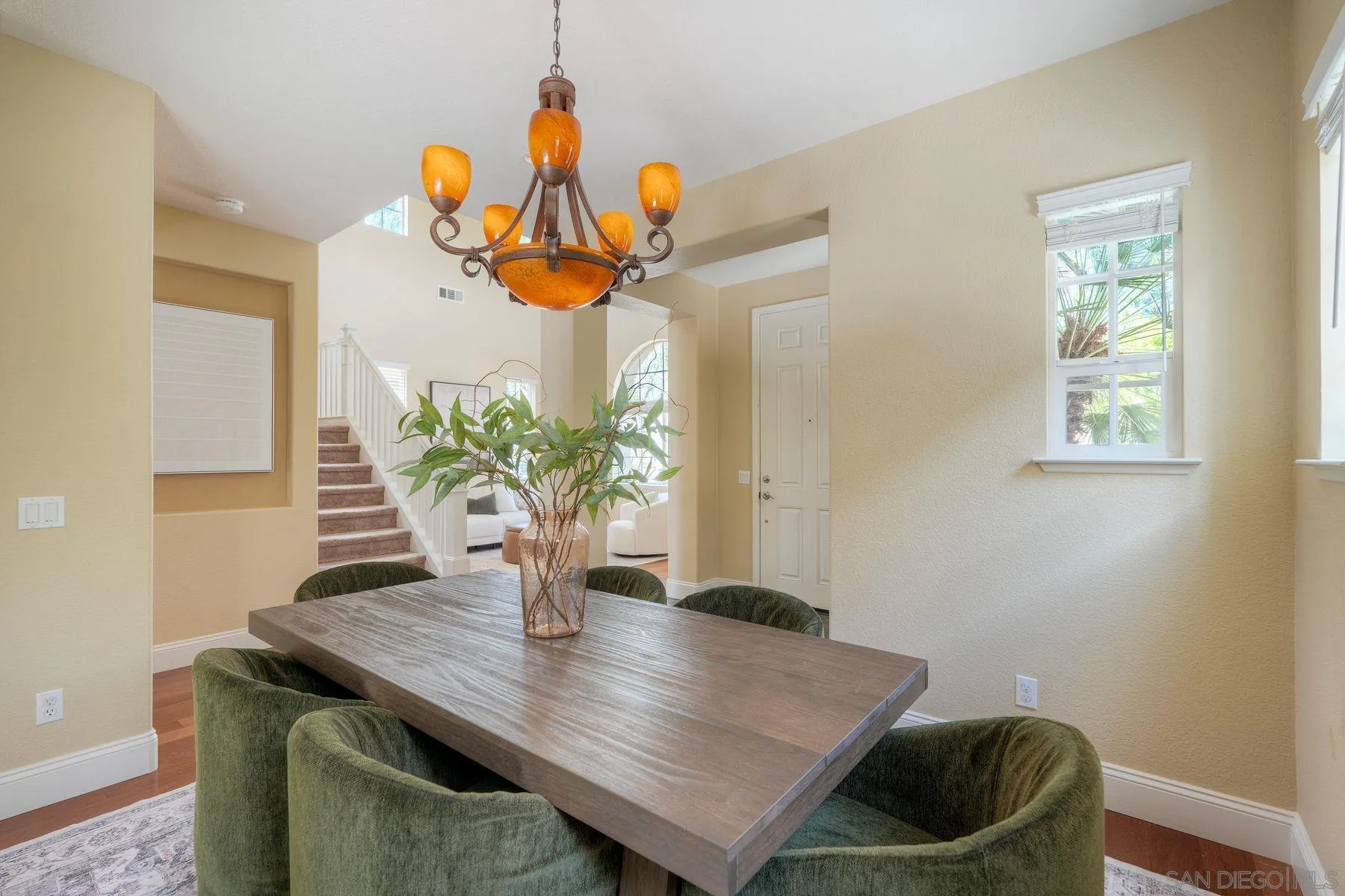 1614 Reflection Street San Marcos, CA 92078 - Photo 9 of 40 a view of a dining room with furniture and wooden floor
