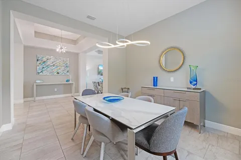 a living room with lots of furniture and view of kitchen