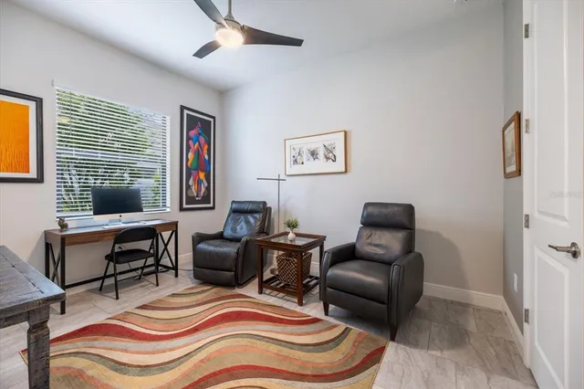 an aerial view of ocean and residential houses with outdoor space