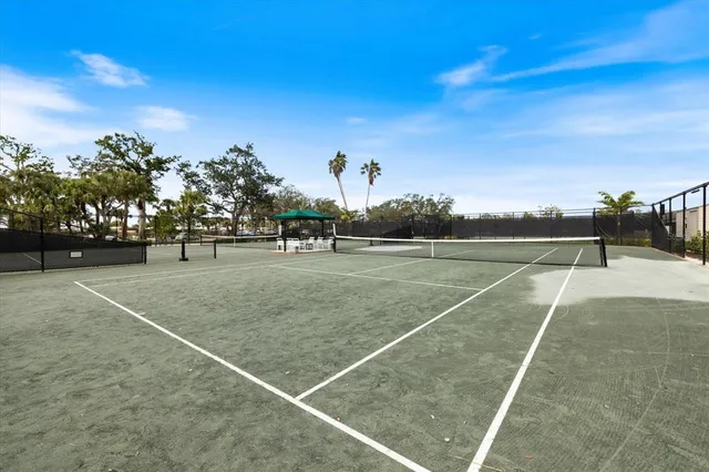 a view of a dining room with furniture a chandelier and wooden floor