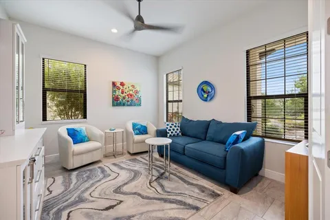 a living room with furniture a rug and a large window