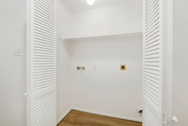 a view of a room with wooden floor