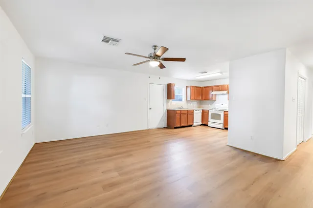 wooden floor in an empty room with a window
