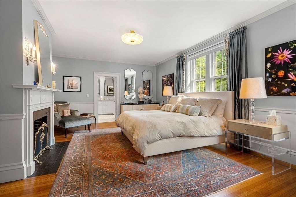 38 Chestnut Street Salem, MA 01970 - Photo 18 of 41 a spacious bedroom with a bed a fireplace and a large window