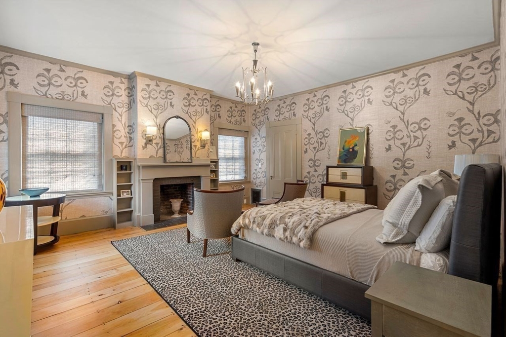 38 Chestnut Street Salem, MA 01970 - Photo 28 of 41 a spacious bedroom with a bed a fireplace with the outer view